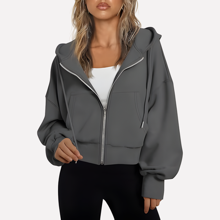 Sudadera holgada de mujer con capucha y cremallera. Bolsillos discretos. Máximo confort y estilo casual.
