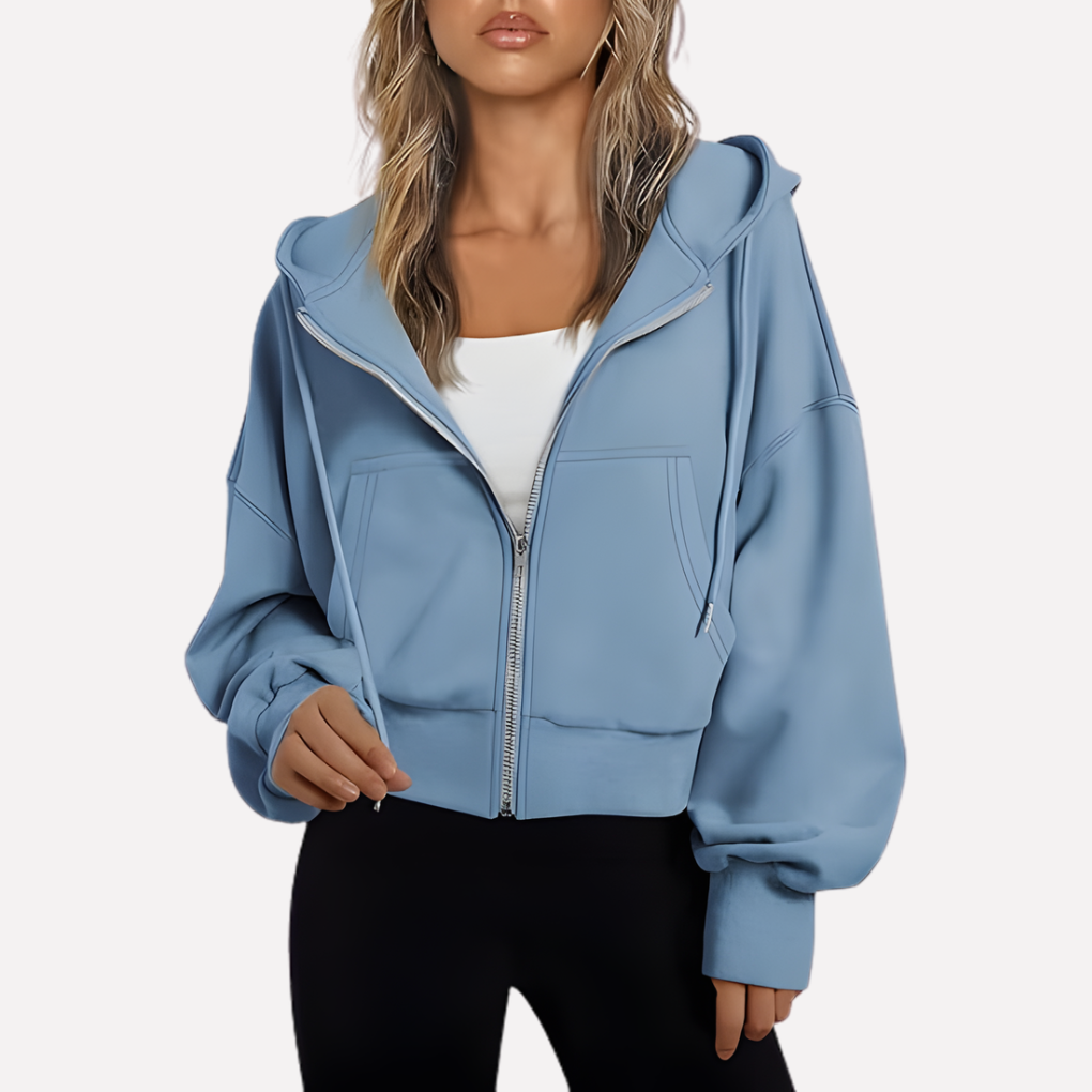 Sudadera holgada de moda para mujer, con capucha, cremallera y bolsillos. Estilo casual y versátil.