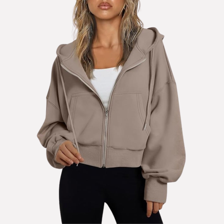 Sudadera de mujer con capucha ajustable, cremallera completa y bolsillos prácticos. Perfecta para el frío.