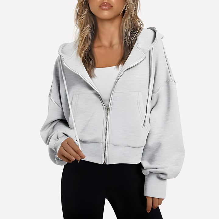 Sudadera casual de mujer con capucha y cremallera. Look relajado, bolsillos frontales. Ideal para diario.