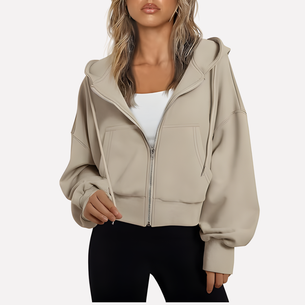 Sudadera con capucha y cremallera para mujer. Diseño moderno, bolsillos funcionales. Comodidad en otoño.
