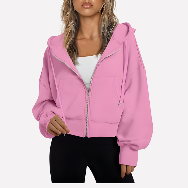 Sudadera con capucha, cremallera frontal y bolsillos laterales. Moda de mujer para otoño-invierno.