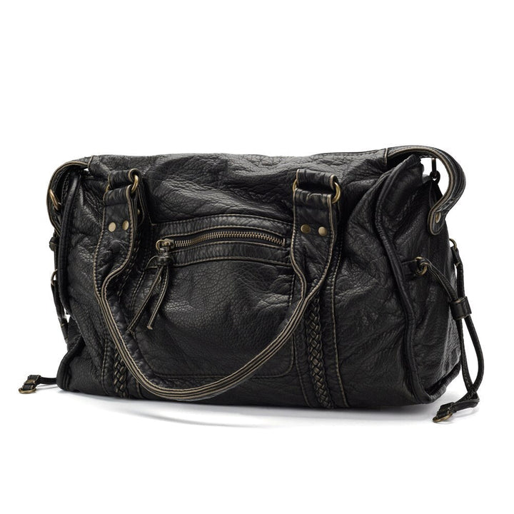 Bolso satchel negro de moda casual para mujer. Versátil como bolso de mano o bandolera.