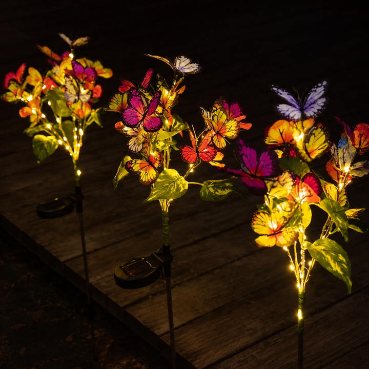 Lámpara solar LED exterior diseño mariposa. Luz cálida, ideal para decoración patio nocturna.