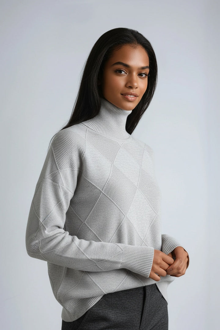 Detalle del cuello alto de un jersey de mujer con estampado de cuadros, cálido y moderno.