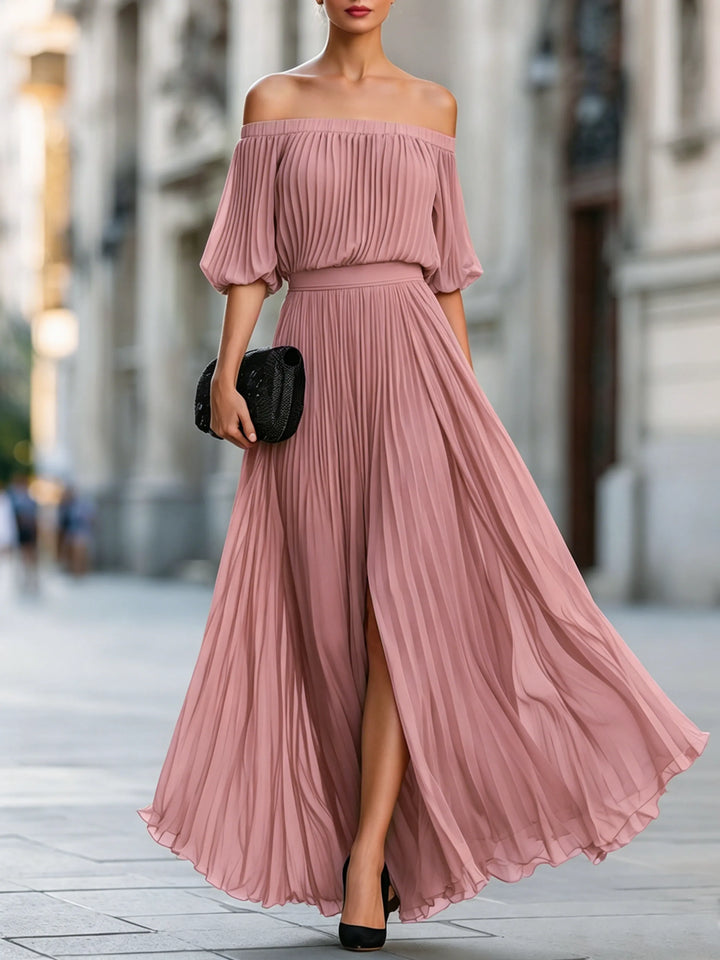 Moda femenina: vestido largo elegante para invitada de boda. Diseño con falda plisada y escote asimétrico.