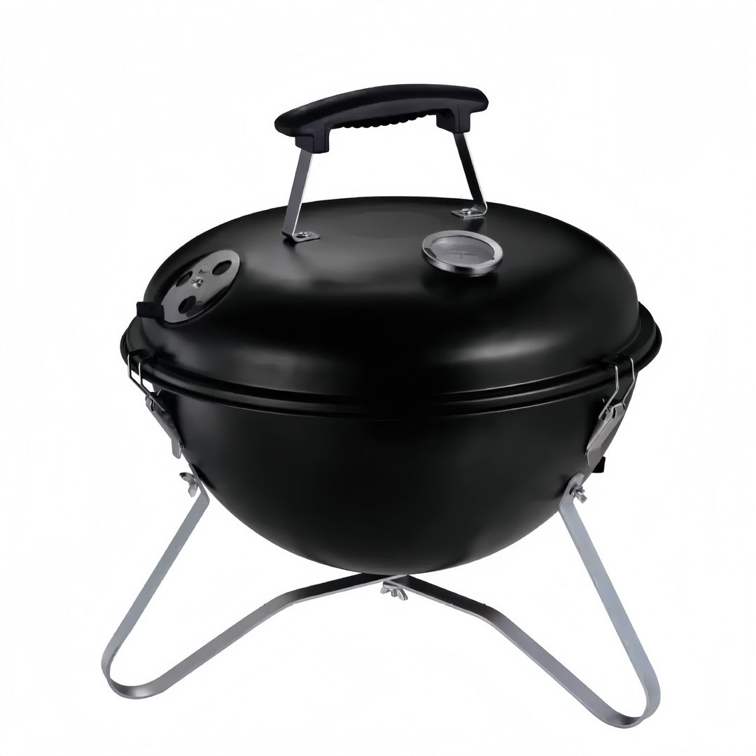 Barbacoa de carbón portátil compacta con tapa para asados al aire libre.