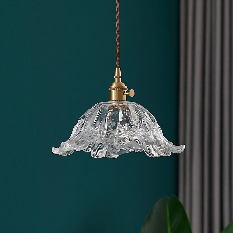 Lámpara colgante dorada de vidrio con forma de flor, ideal para iluminación de interiores.