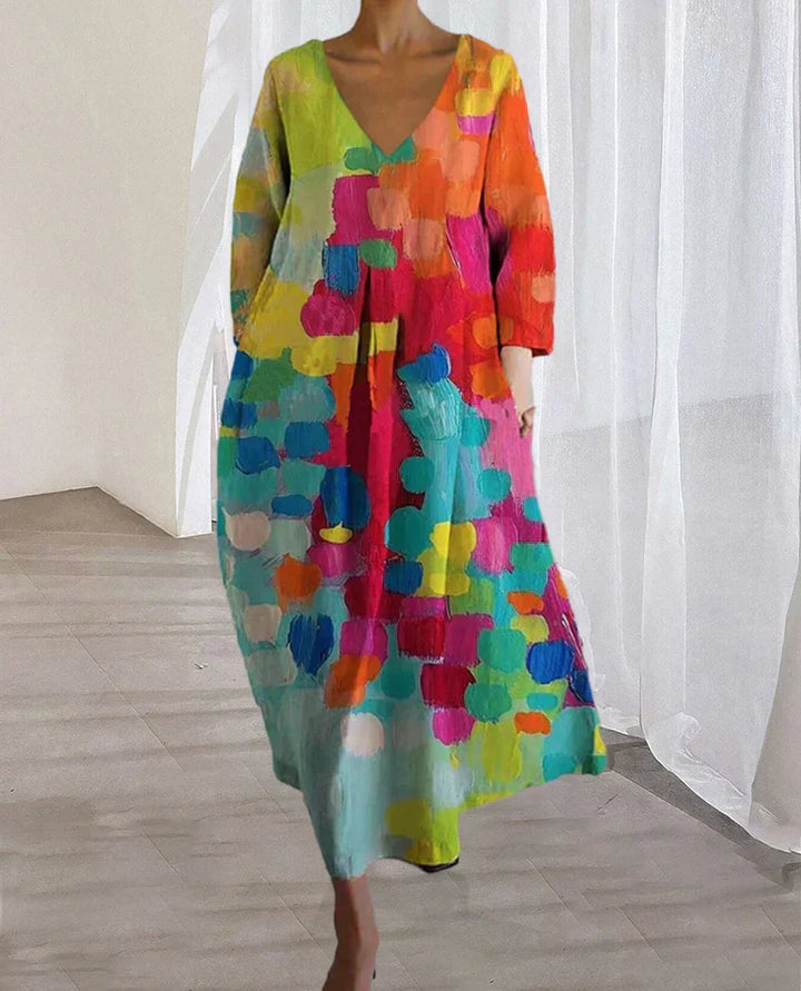 Vestido de fiesta largo y fluido con estampado colorido. Escote en V, perfecto para eventos de verano, bodas y ceremonias.