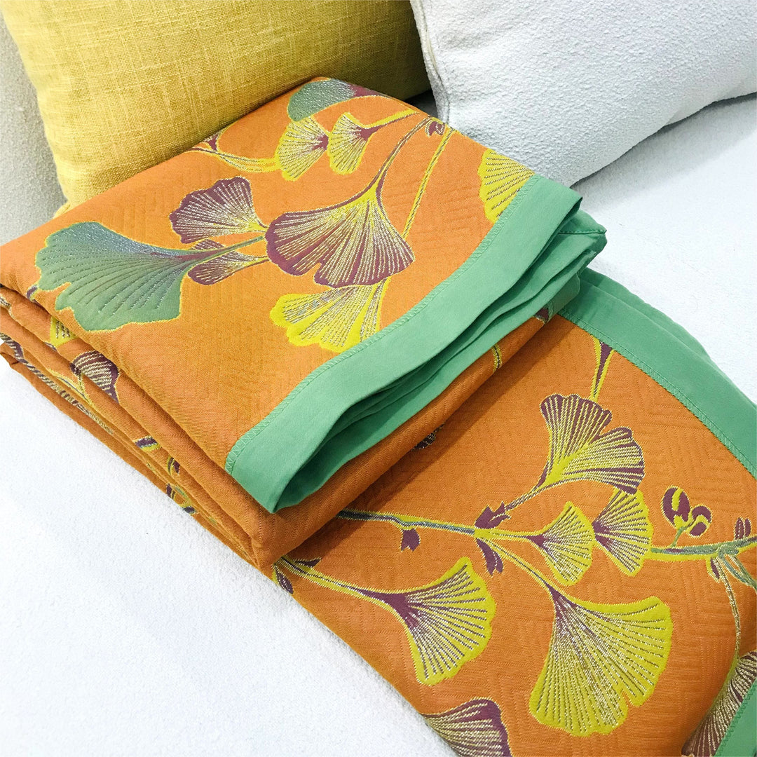 Colcha de algodón reversible jacquard doblada, mostrando su textura suave y diseño versátil.