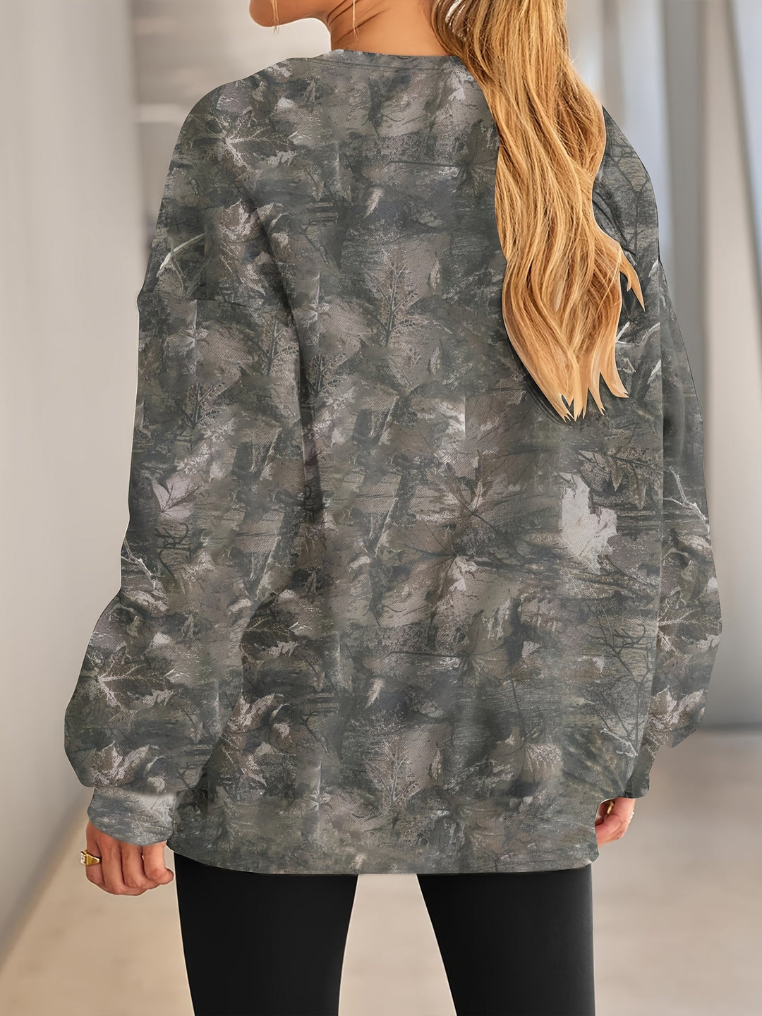 Primer plano de la tela de sudadera oversize camuflaje para mujer. Textura suave y patrón único.