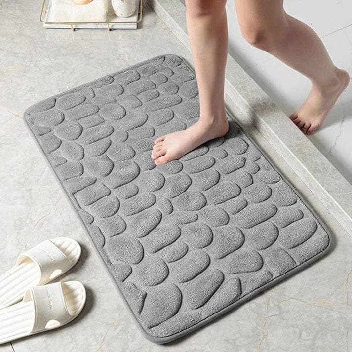 Alfombrilla antideslizante para ducha, ofrece confort y seguridad en el baño, disponible en gris y negro.