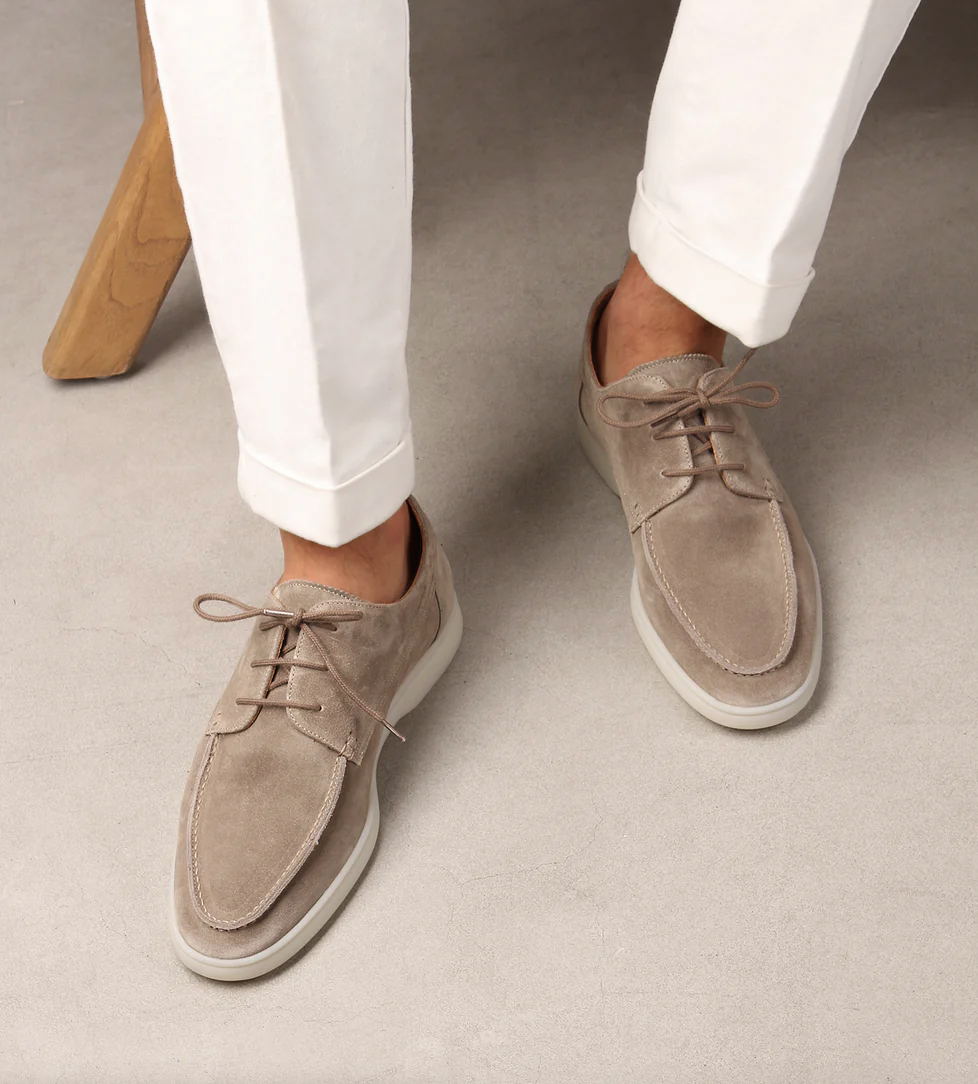 Hombre luciendo bluchers de ante marrones, combinando con pantalón chino para un estilo casual.