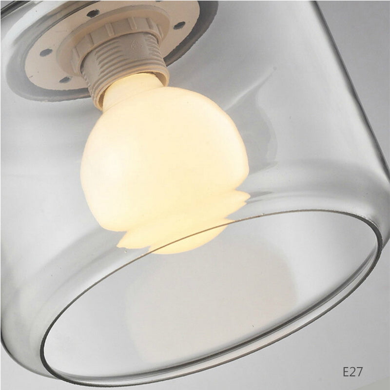Iluminación elegante: lámpara colgante con pájaro y cilindro de vidrio. Ideal para decoración.