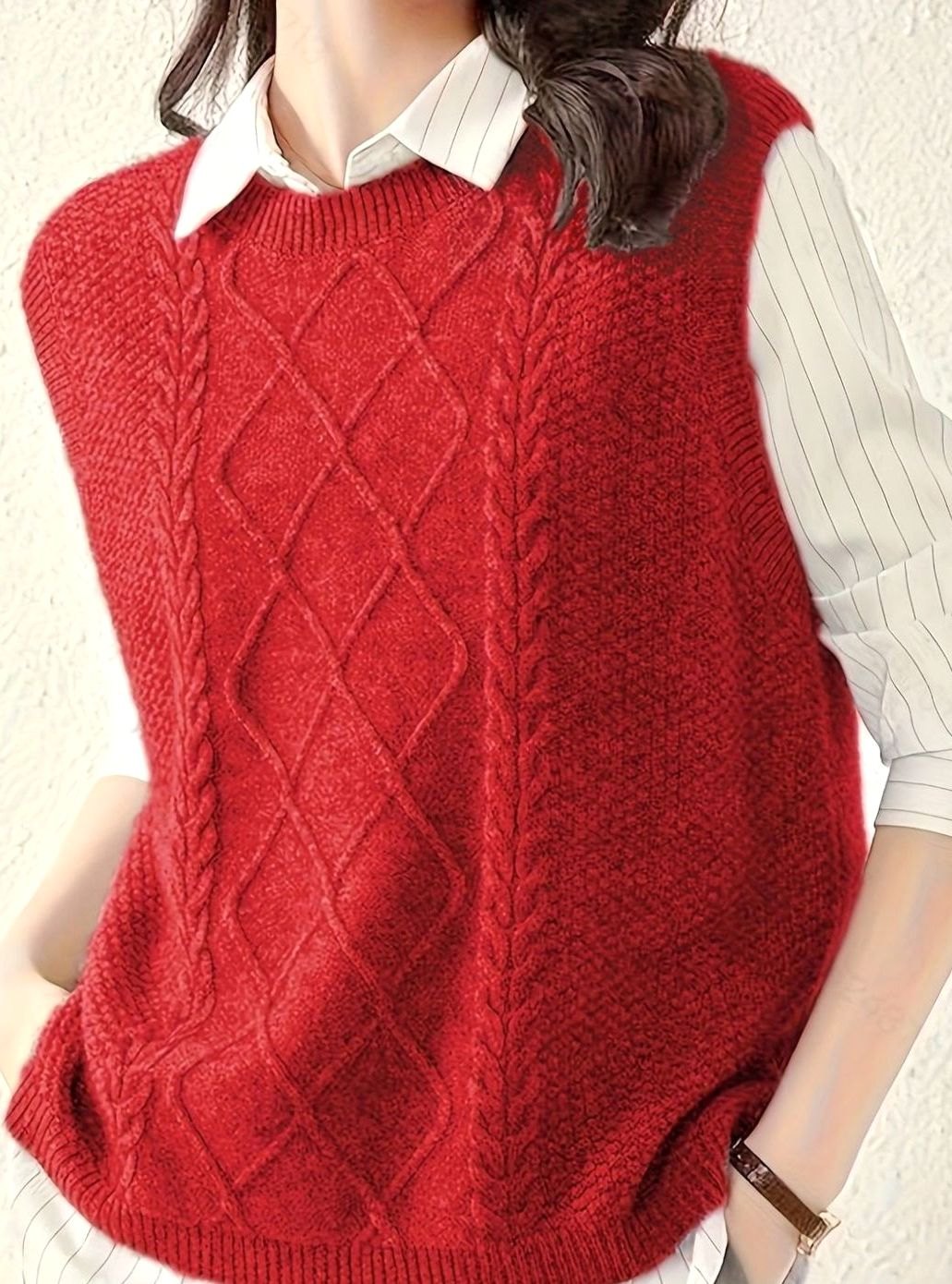 Mujer luciendo chaleco de punto trenzado. Prenda sin mangas, cuello redondo, ideal para capas en otoño.