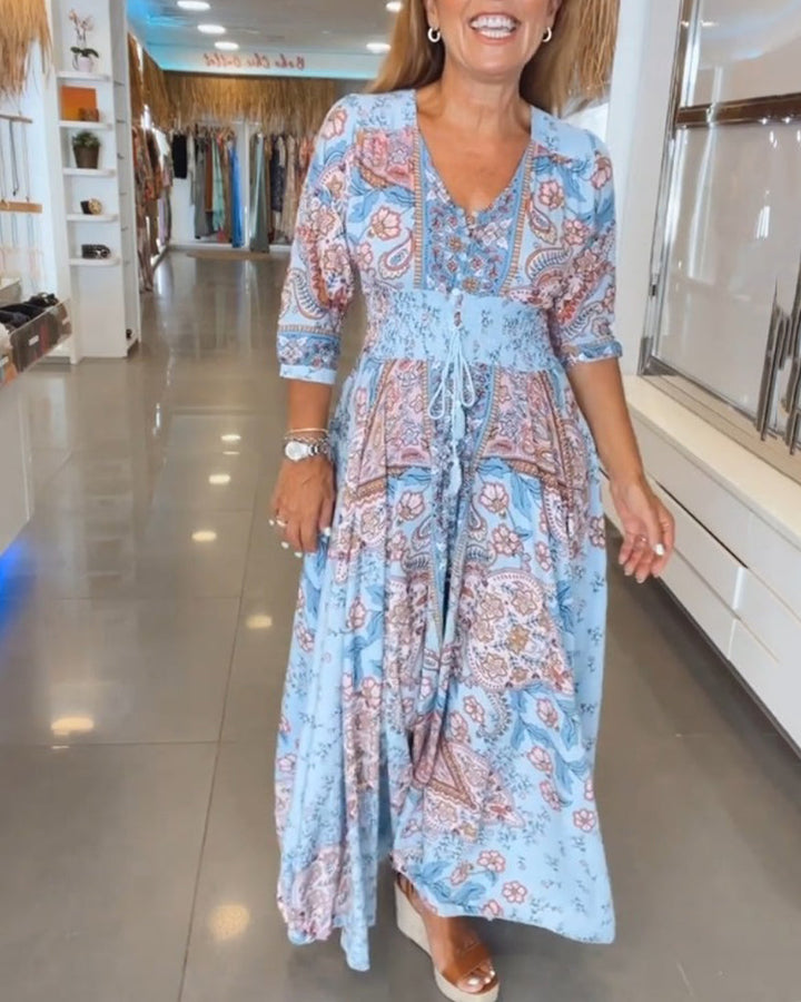Vestido fluido estilo bohemio con escote V y estampado vibrante, perfecto para primavera.
