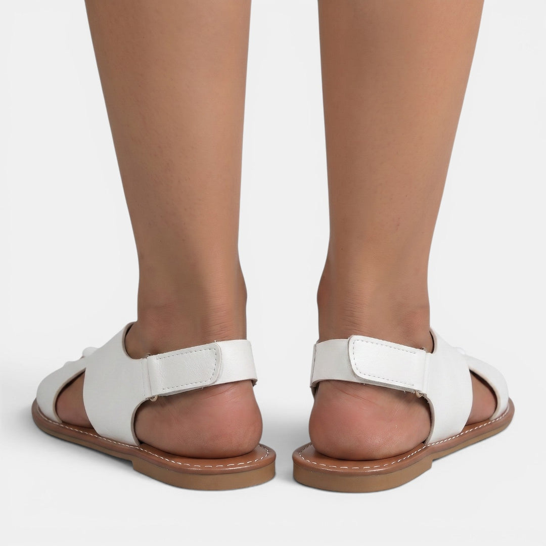Sandalias planas de mujer en un look casual de verano. Calzado femenino cómodo y de moda para paseos y relax.