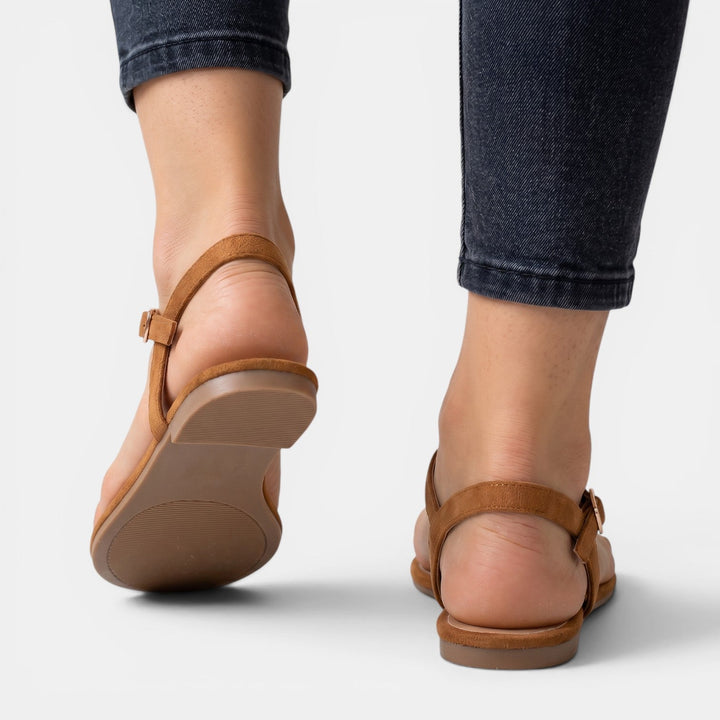Sandalias planas elegantes de mujer combinadas con atuendo de verano, un look cómodo y de moda femenina.