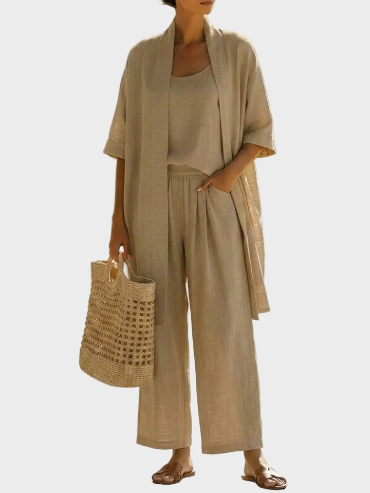 Lino de mujer, cómodo y chic. Conjunto de tres piezas con pantalón ancho y chaqueta larga, ideal para el calor.