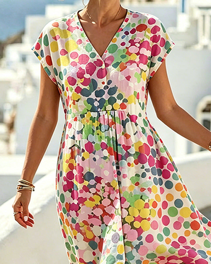 Elegante vestido fluido de verano para mujer, beige con lunares multicolores y escote V. Moda femenina versátil.
