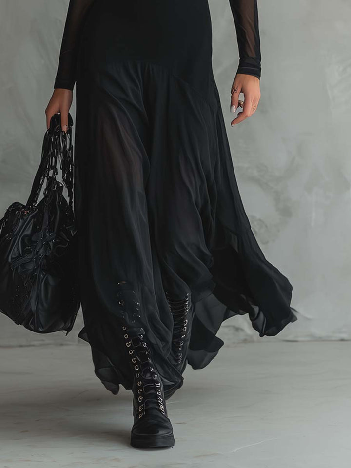 Vestido negro elegante para mujer, corte maxi. Mangas transparentes que añaden un toque sofisticado a tu estilo.