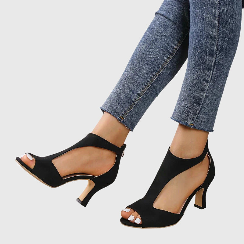 Tacones ortopédicos elegantes para mujer, en rosa y negro, combinan moda, comodidad y soporte ergonómico.