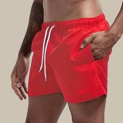 Shorts de baño para hombre con prácticos bolsillos laterales, ideal para el verano, playa y piscina.