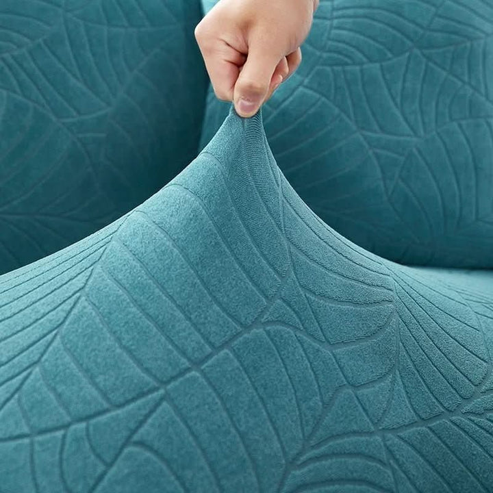 Protector de sofá elástico gris, ajuste perfecto para renovar tu sala moderna.