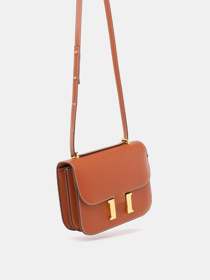 Mujer vistiendo bolso bandolera pequeño tropical, look casual de verano, ligero y moderno.