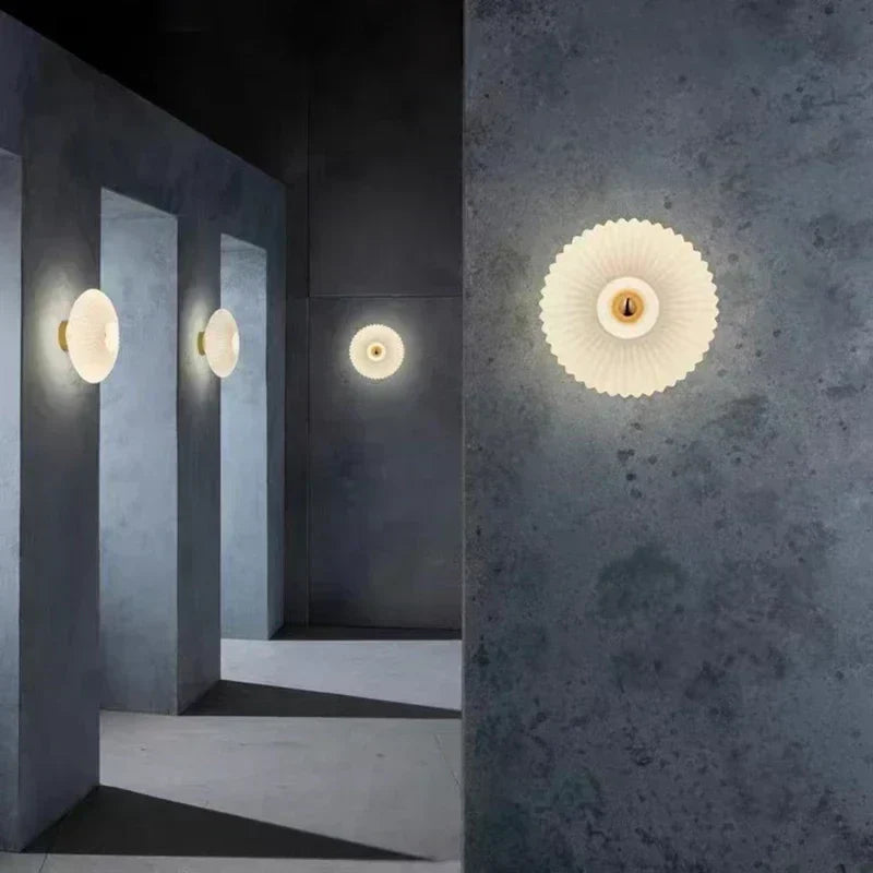 Lámpara de pared moderna con vidrio ondulado, ideal para crear un ambiente cálido en dormitorio o sala de estar.