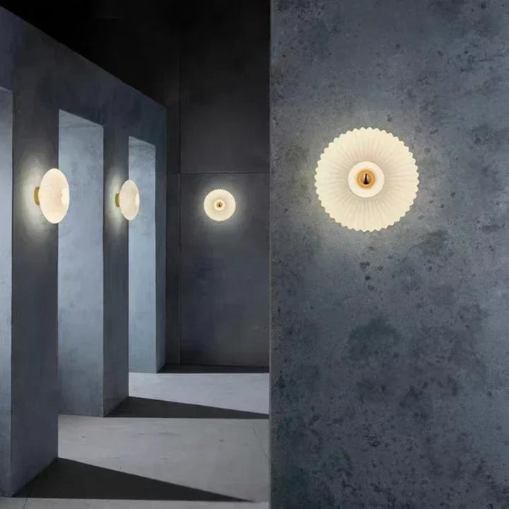 Lámpara de pared moderna con vidrio ondulado, ideal para crear un ambiente cálido en dormitorio o sala de estar.