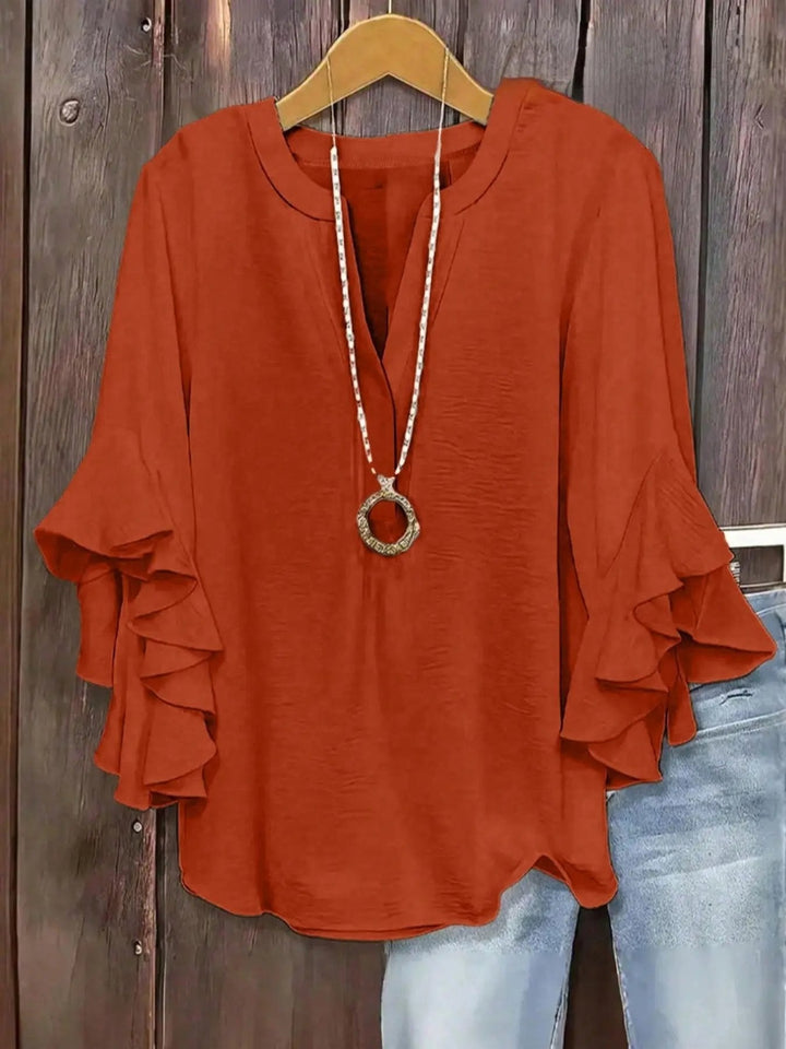Blusa con mangas acampanadas y cuello V para mujer. Estilo versátil, ideal para día o noche.