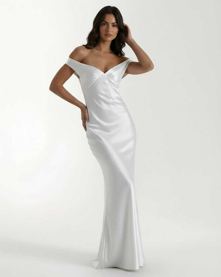 Vestido maxi blanco Elara, off shoulder. Tela fluida, elegante, ideal para noche, fiesta o gala formal.