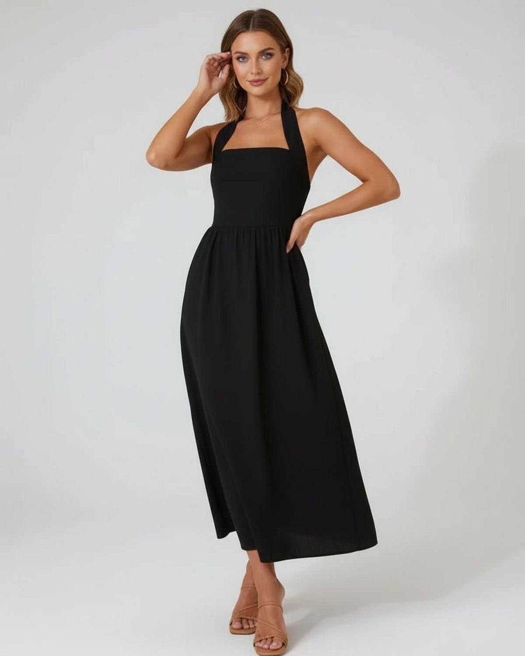 Vestido midi negro halter para mujer, de tejido fluido y fresco, ideal para la temporada veraniega.