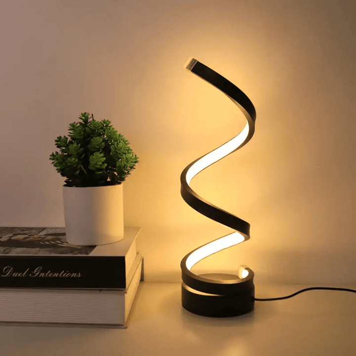 Elegante lámpara de mesa LED espiral para dormitorio o sala de estar. Luz regulable que decora y crea ambiente.