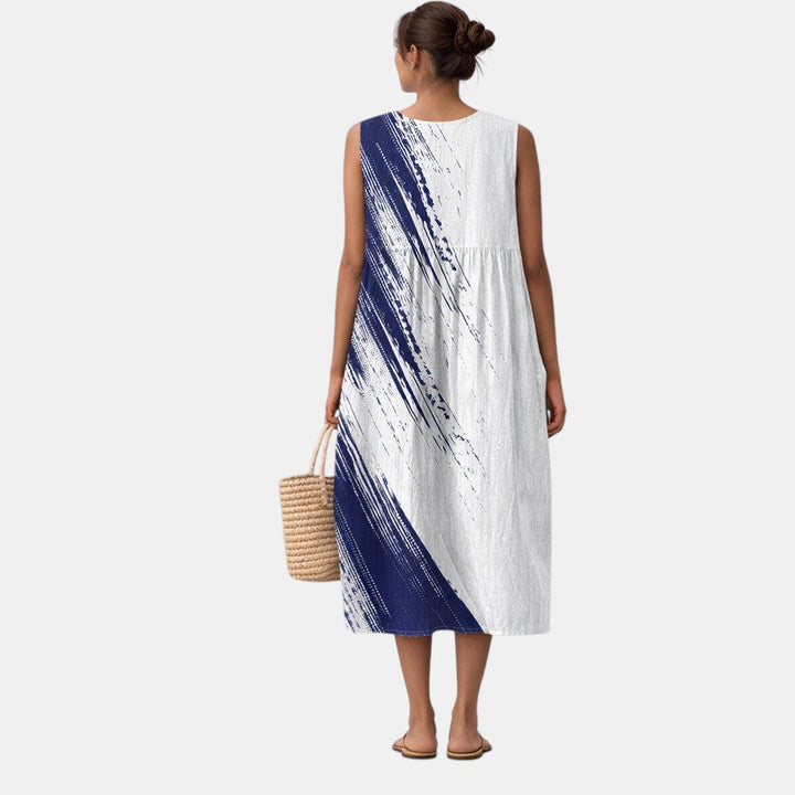 Elegante vestido midi de mujer con diseño sin mangas y vibrante estampado abstracto. Moda versátil para primavera.