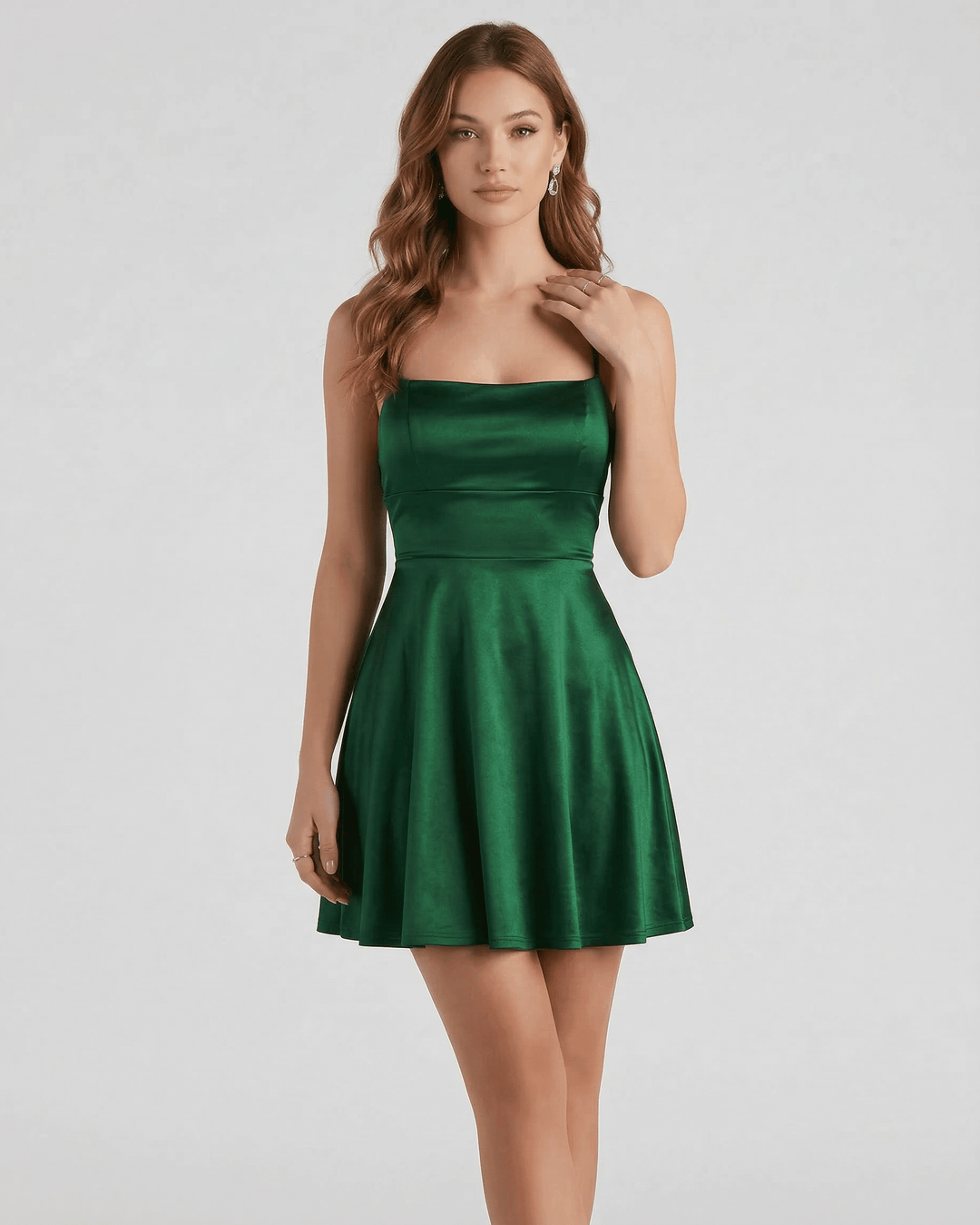 Modelo posando con vestido mini esmeralda de fiesta, elegante y sin mangas, ideal para eventos de noche y cenas.