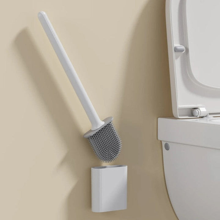 Organización del baño: escobilla de inodoro flexible con soporte de pared para mantener el área limpia y ordenada.