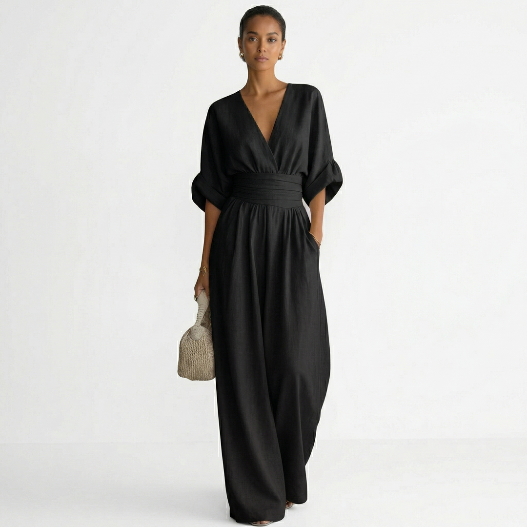 Mono largo de mujer de lino elegante con cinturón que estiliza la figura. Escote V, moda primavera-verano.