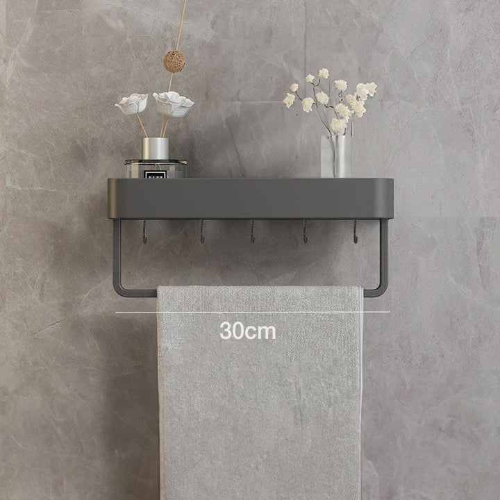 Estante flotante gris para baño, perfecto para organizar productos de higiene.