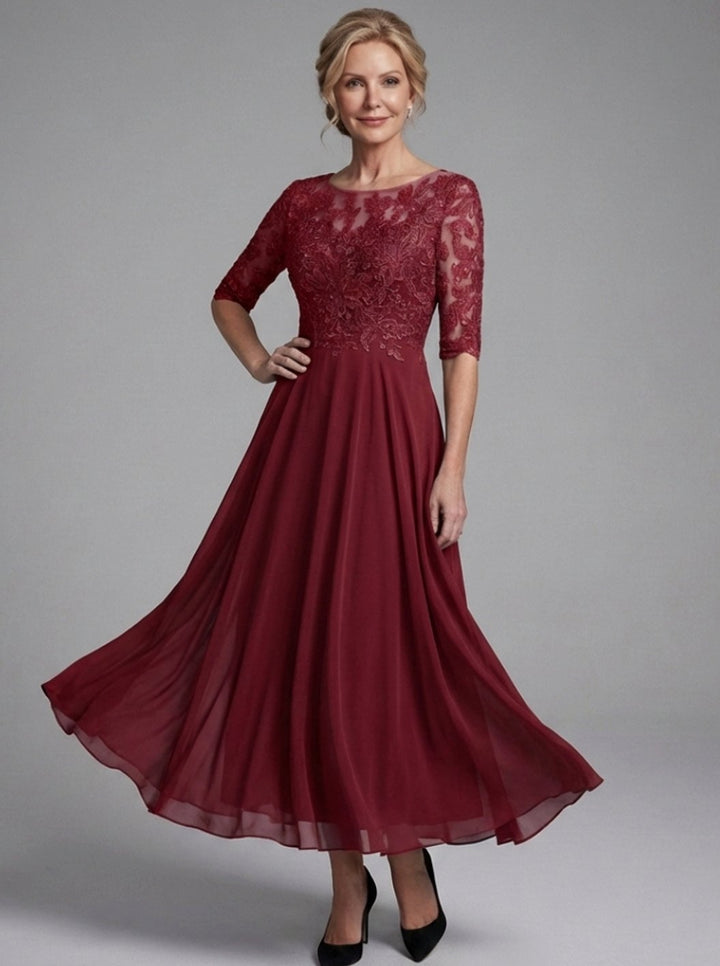 Vestido midi con encaje delicado y mangas transparentes de chifón. Look elegante y fluido para mujer.
