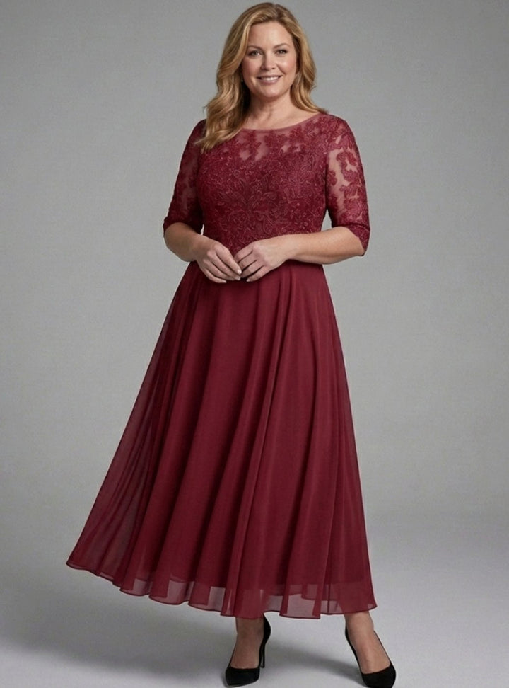 Vestido midi de encaje y mangas transparentes, ideal para invitadas de boda o fiestas formales.