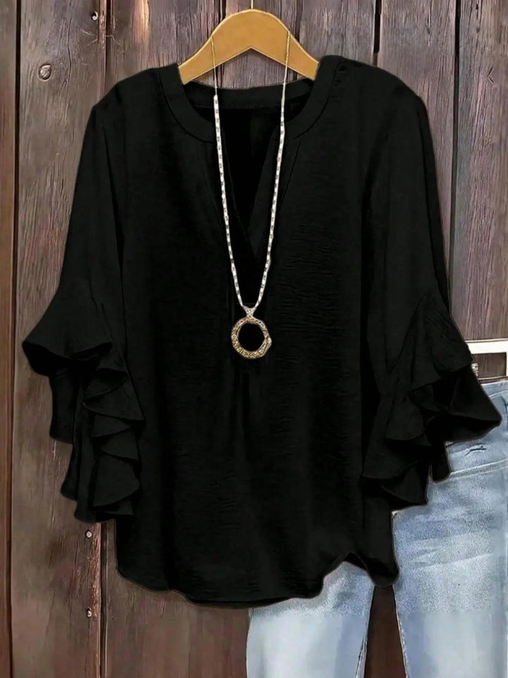 Cómoda blusa de mujer, diseño con escote V y mangas acampanadas. Estilo fresco y moderno.