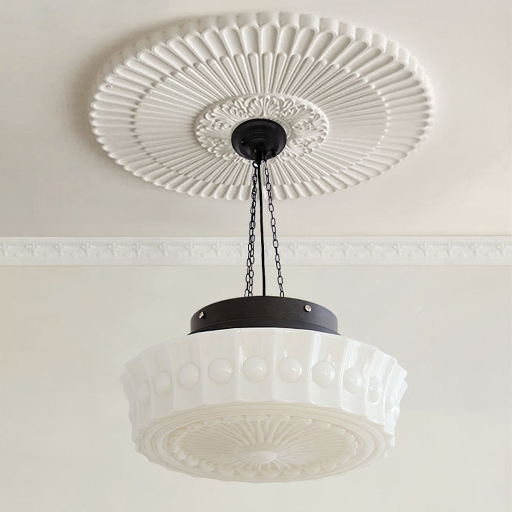 Moderna lámpara colgante cilíndrica de vidrio y hierro forjado para sala de estar.