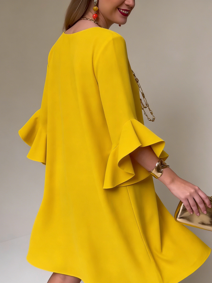 Vestido de mujer fluido con elegante manga volante. Ideal para verano, casual y femenino. Comodidad y estilo.