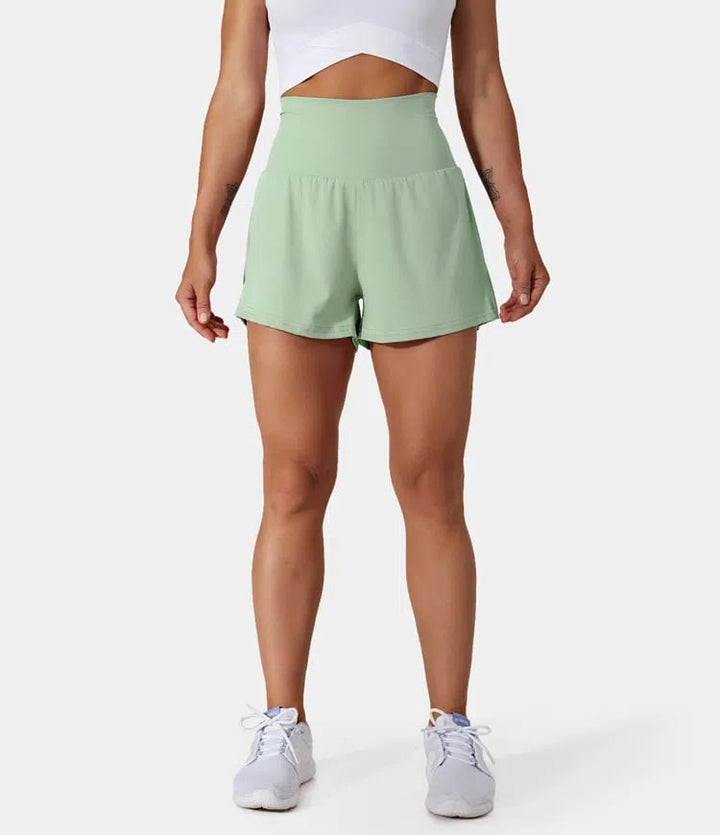 Short de entrenamiento para mujer, cintura alta, bolsillos, tejido transpirable.