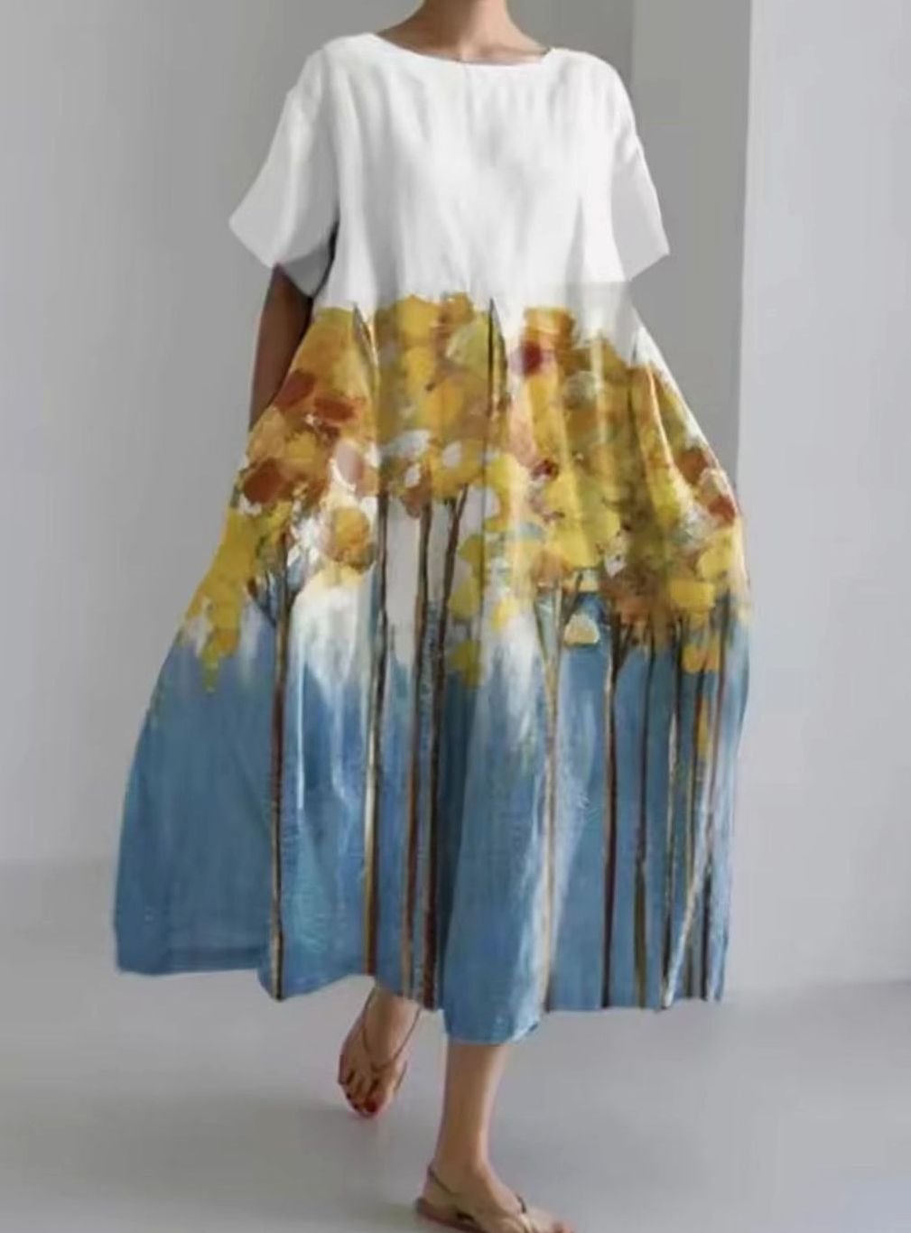 Maxi vestido para mujer con apliques florales y cuello redondo. Diseño ligero y fluido, perfecto para la temporada cálida.