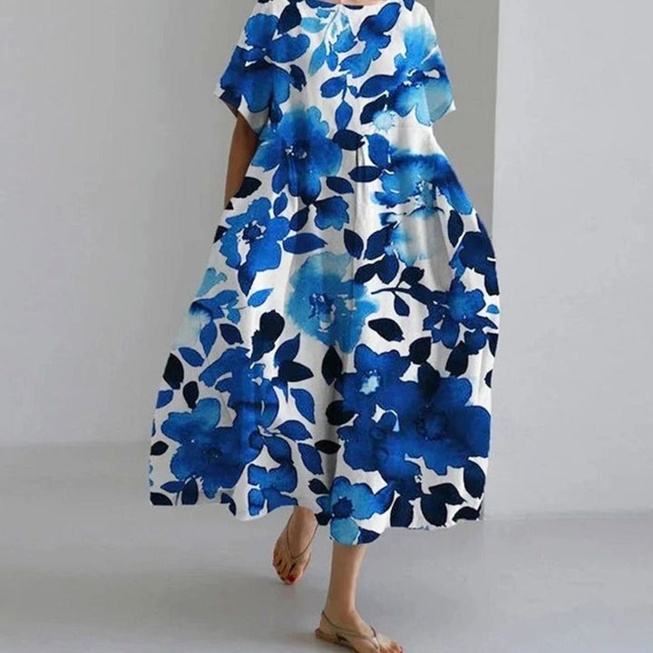 Vestido floral midi de mujer, manga corta, corte holgado y bolsillos. Perfecto para el verano casual.