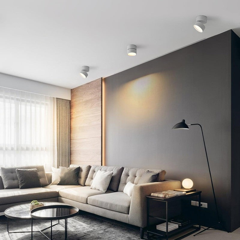 Foco LED minimalista de montaje superficie, luz cálida para ambientes modernos.