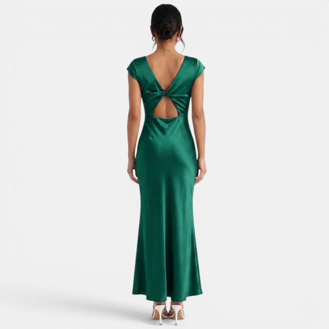Vestido de fiesta verde botella, largo, con escote V y cut-outs modernos. Ideal para eventos formales de noche.